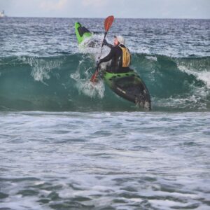 Profish 400 kayak riding a wave during surf launch