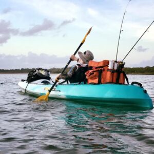 Young boy kayak fishing from a viking espri