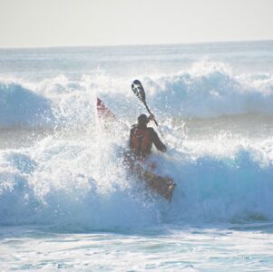 Jason Milne, AKA Paddle Guy, on his Viking Profish Reload during a beach launch in the surf