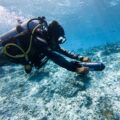 Scuba diver exploring coral reef with ASIWO U1