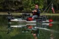 Fully rigged Bonafide PWR129 fishing kayak on the water with angler seated and electronics mounted.