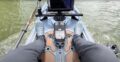 Angler standing on Bonafide PWR129 fishing kayak showing stable deck and clean electronics setup.