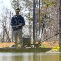 Fisherman standing and casting from a Native Slayer Propel 10 LTE kayak