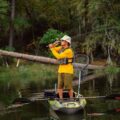 Angler standing and casting from Pelican Catch 110 Mode kayak