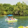 Family enjoying a Pelican Monaco DLX Angler pedal boat on calm water