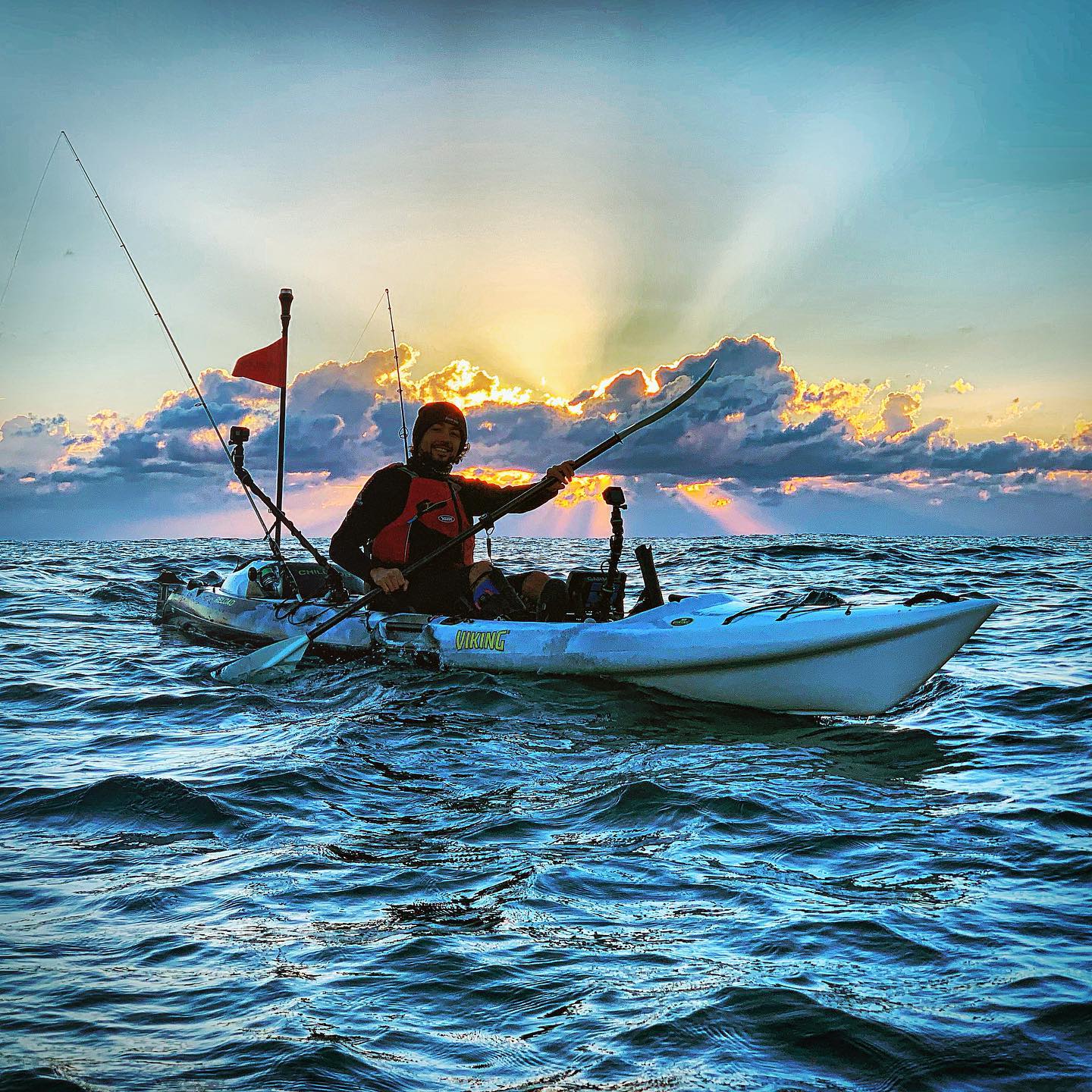 Viking profish kayak fishing coaching session at sunrise, paddler offshore on a viking profish kayak in open ocean conditions