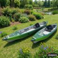 Odyssey Solo inflatable kayaks displayed on green grass in a garden setting, showcasing open deck layout and touring design